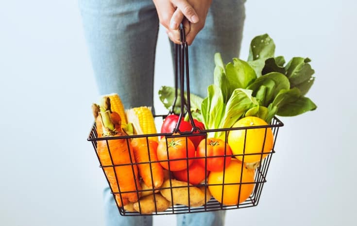 woman holding grocery basket